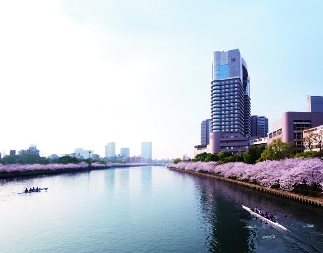 Imperial Hotel, Osaka overlooking the Okawa River, where cherry blossoms line the banks in peak spring color.